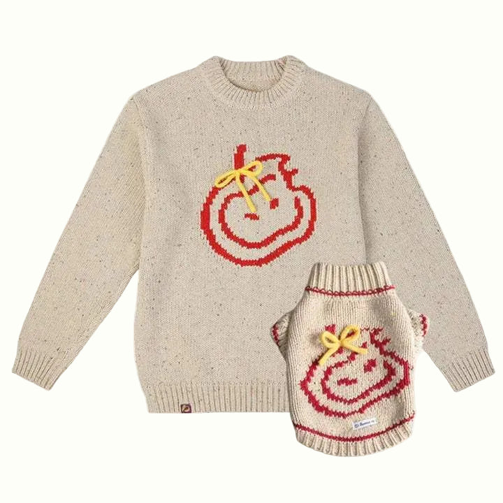 Beige sweater with red and yellow design on a white background