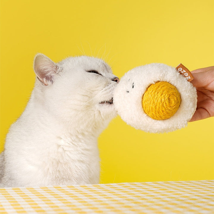 Cat engaging with boiled egg sisal rope ball for mental stimulation 