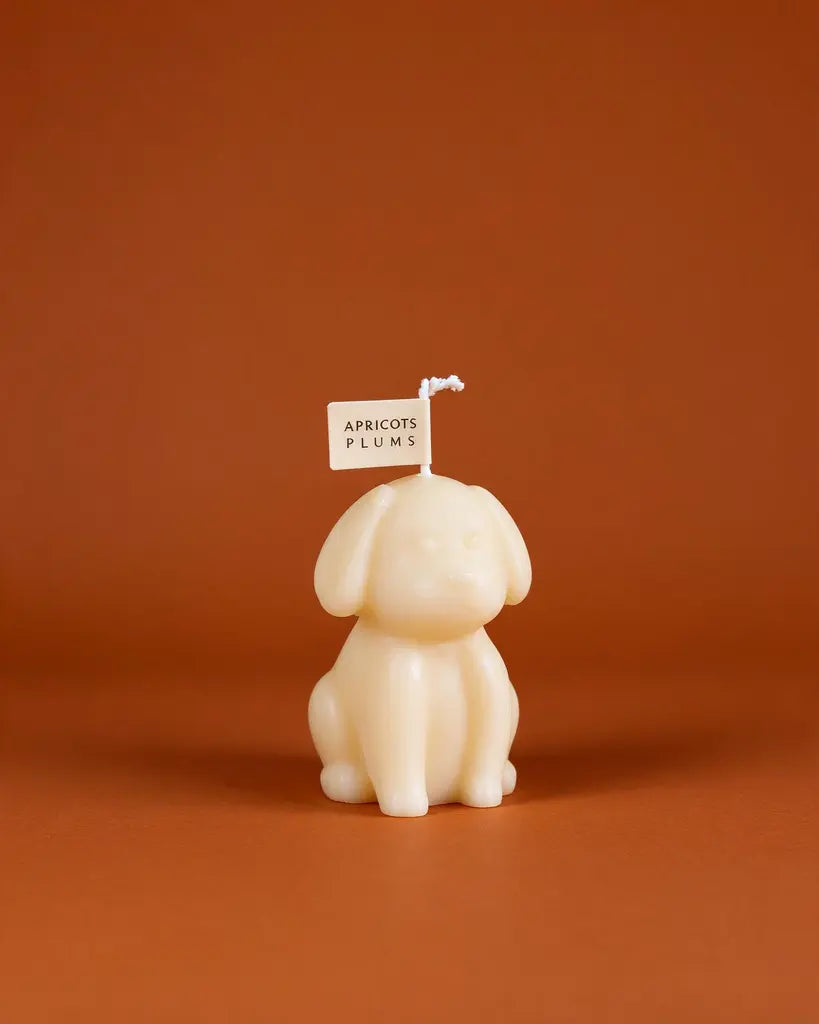 Cute ivory puppy-shaped scented candle made with natural plant wax, displayed as minimalist home decor 