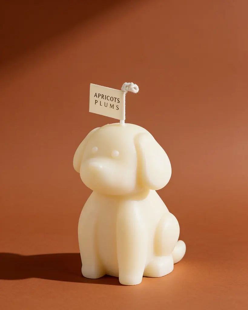 Cute ivory puppy-shaped scented candle made with natural plant wax, displayed as minimalist home decor 