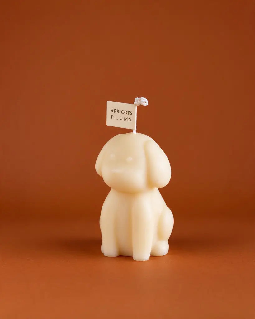 Cute ivory puppy-shaped scented candle made with natural plant wax, displayed as minimalist home decor 