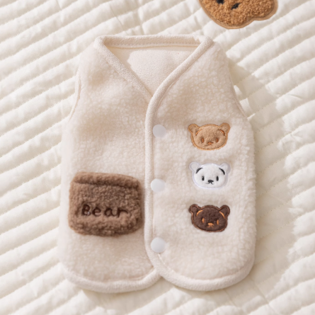 White pet outfit with bear designs on a textured surface