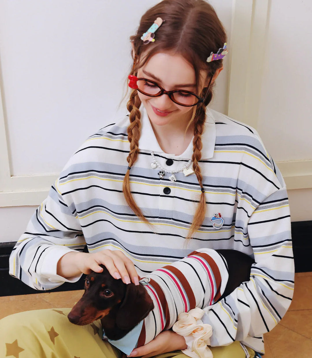 Woman and dog wearing matching outfits