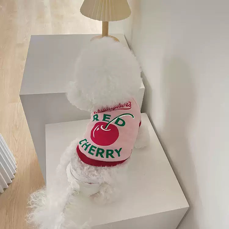 Small dog with 'Red Cherry' branding on a white surface
