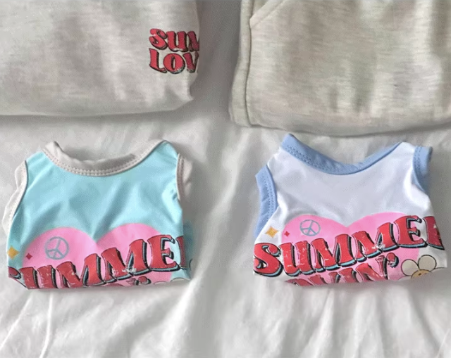 Two dog's tank tops with 'Summer Lovin' text on a white background