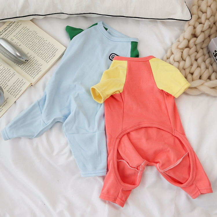 Two pet jumpers, one light blue and one LightCoral, on a textured surface.