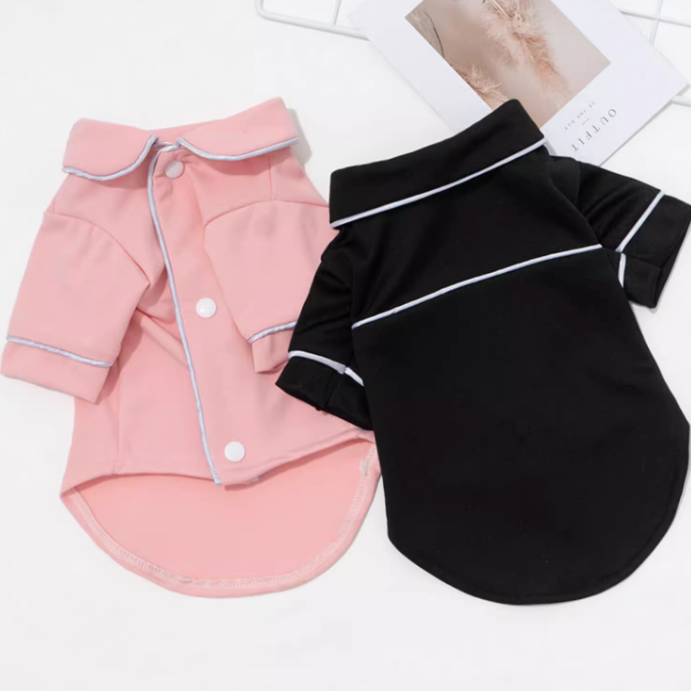 Pink and black pet pajamas with white buttons on a white background