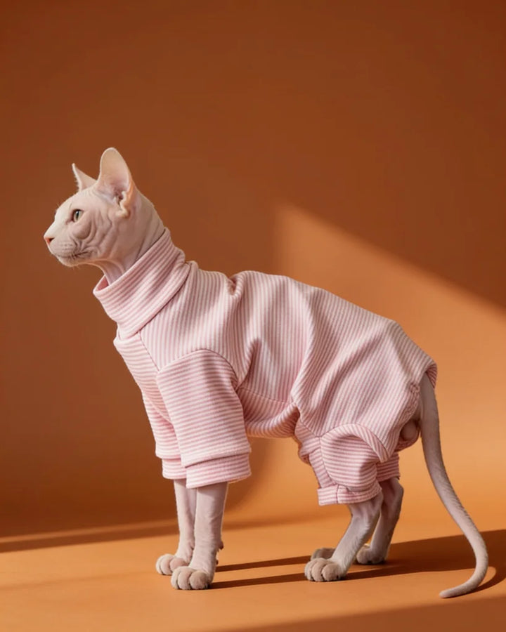 Sphynx cat wearing a soft pink striped fleece onesie for fall and winter warmth
