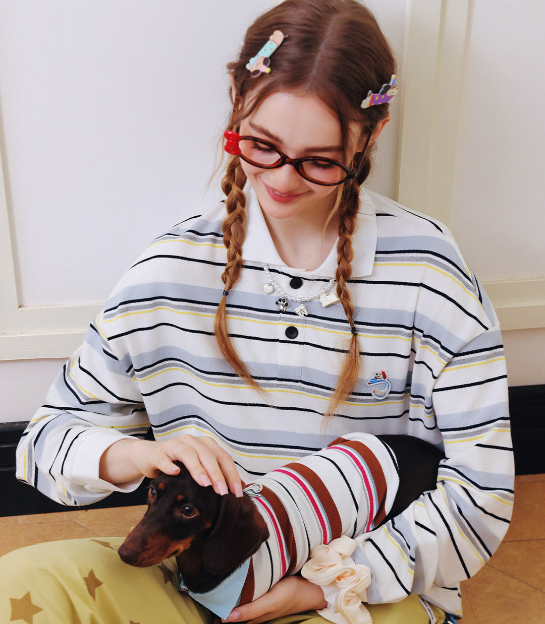 Woman and dog wearing matching outfits