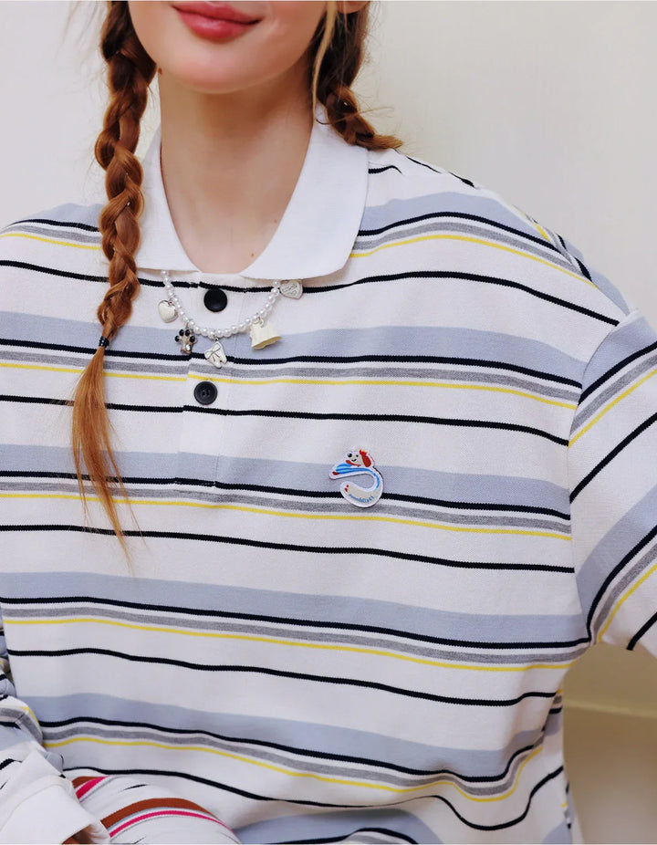 Close-up of a person wearing a striped shirt with decorative buttons