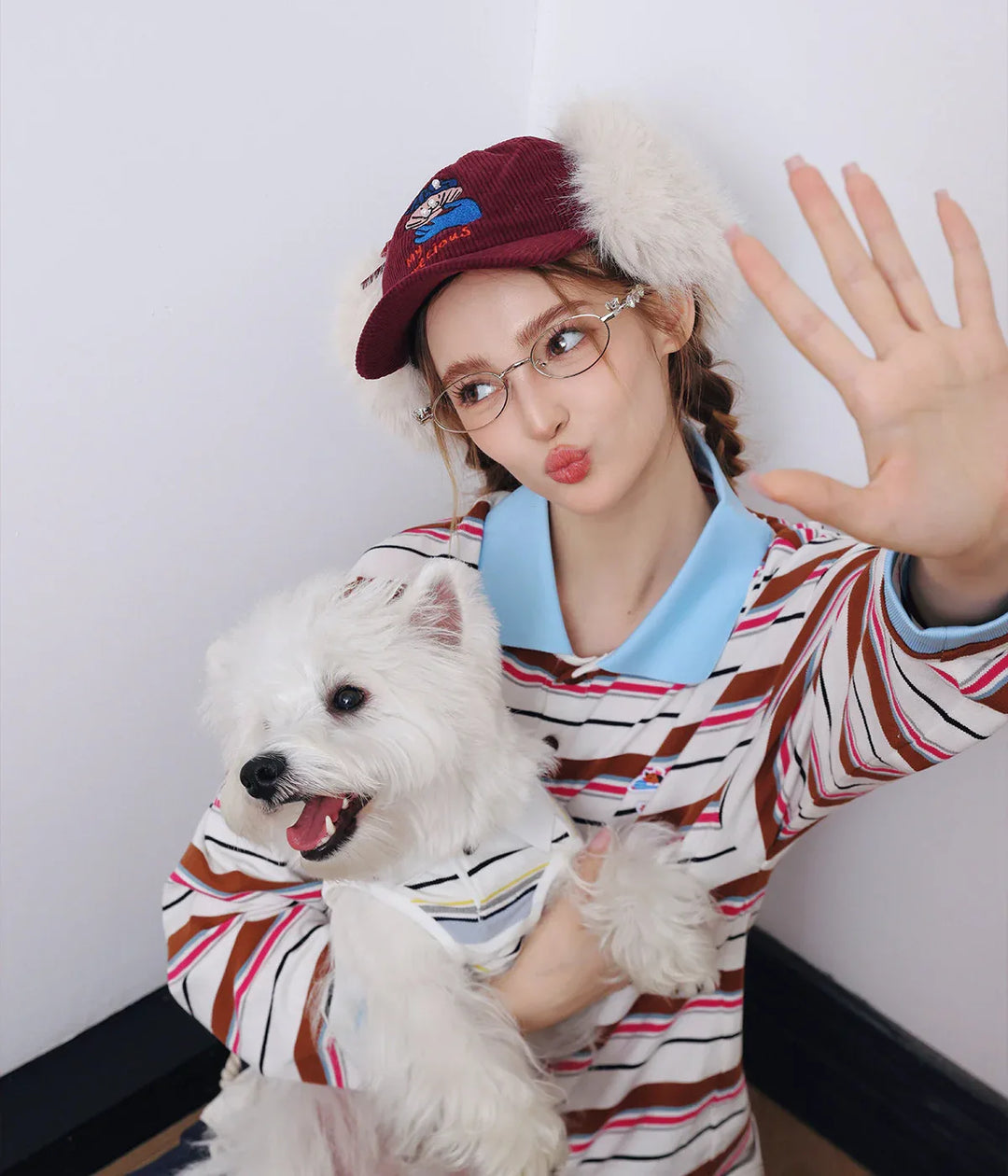 Woman and dog wearing matching outfits