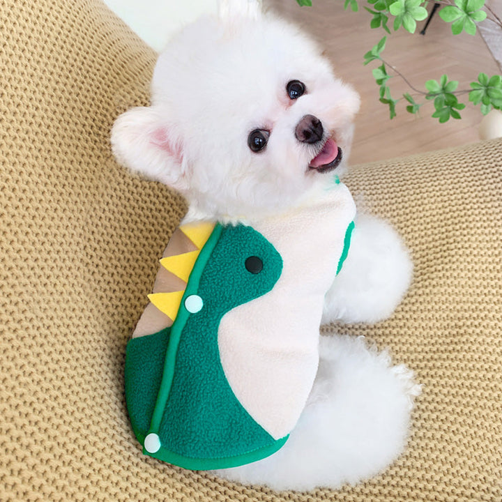 Puppy wearing cute button through green dinosaur fleece vest.