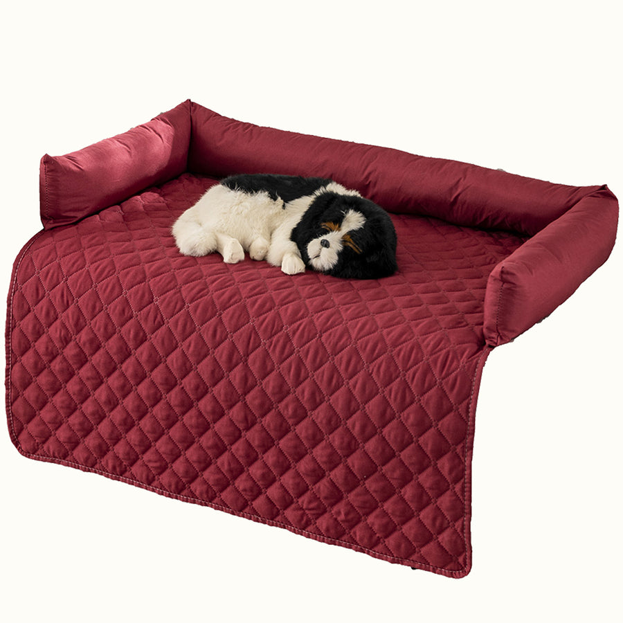 dog sleeping on a red sofa protector mat with bolsters