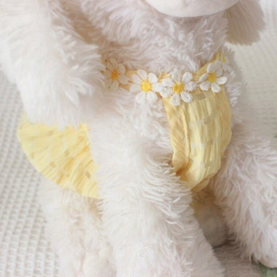 dog wearing daisy neck yellow dress